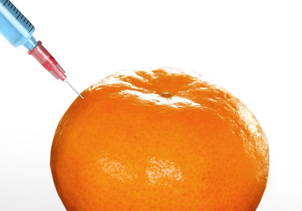 syringe sticked into orange,GMO